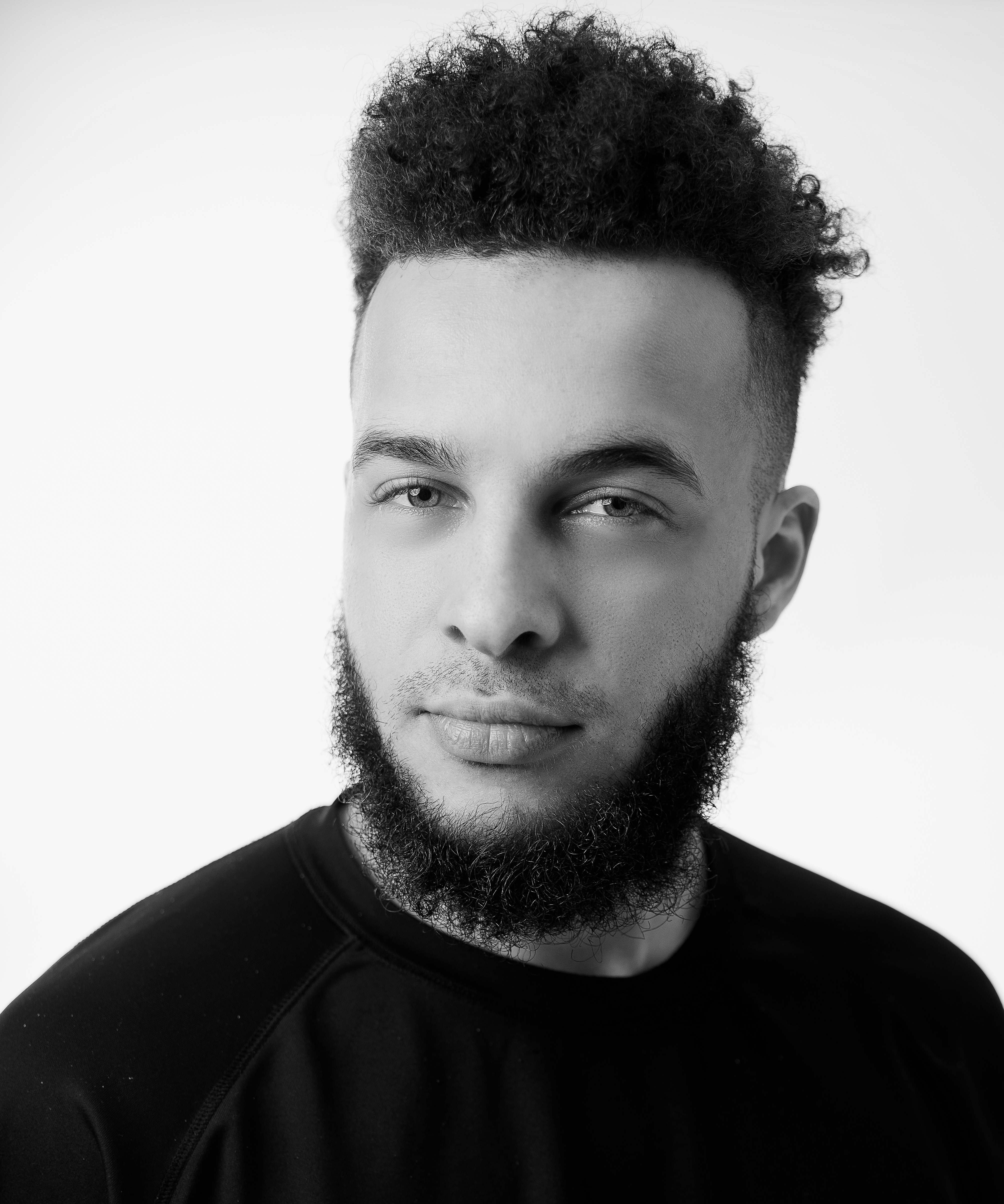 Man with thick curly beard with no mustache